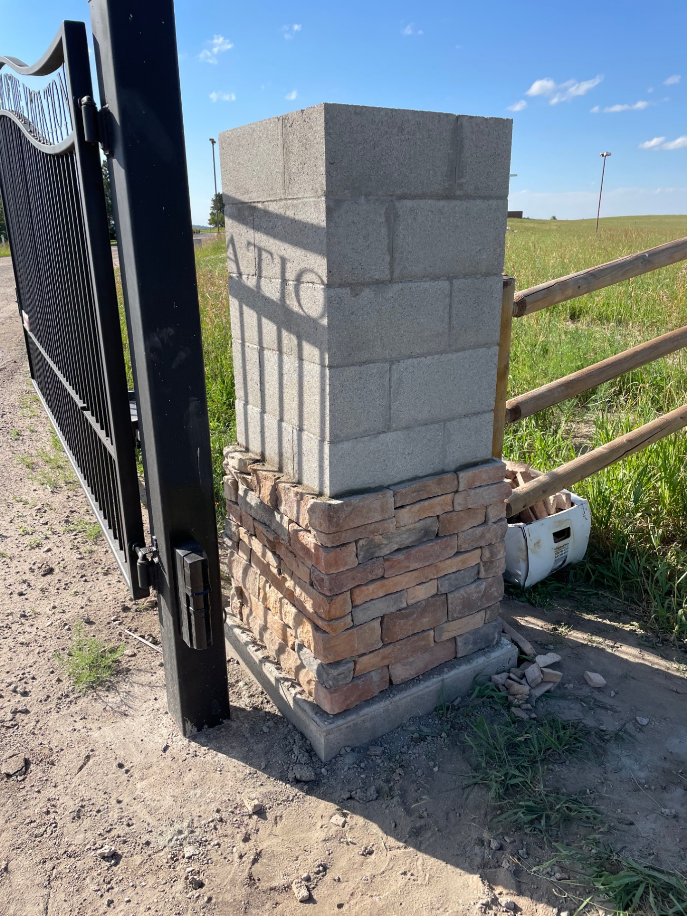 Stone entry column construction in progress with block core
