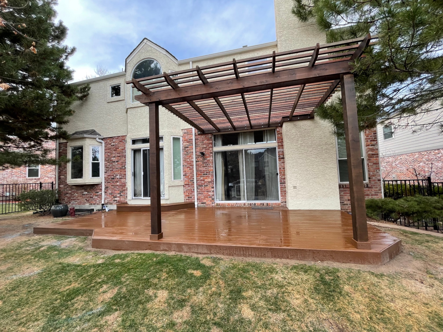 Custom hardwood deck with attached pergola behind a Colorado home